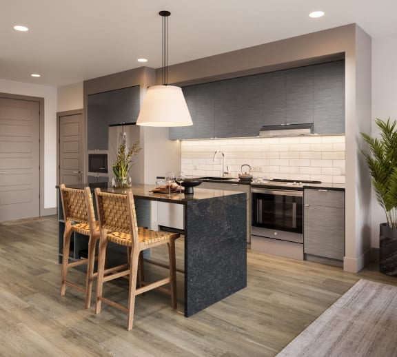 a kitchen with an island and a table with chairs at Bemiston Place Apartments, Clayton, MO 63105