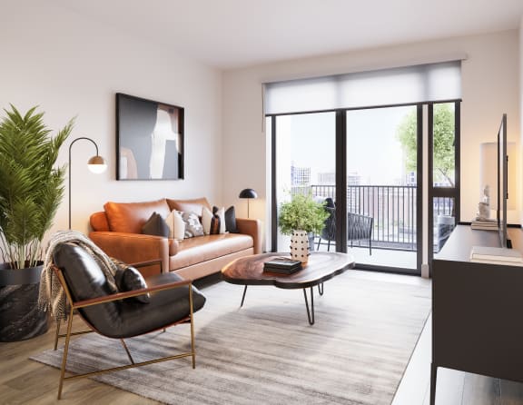 a living room with a couch and a coffee table and a balcony at Bemiston Place Apartments, Clayton, MO
