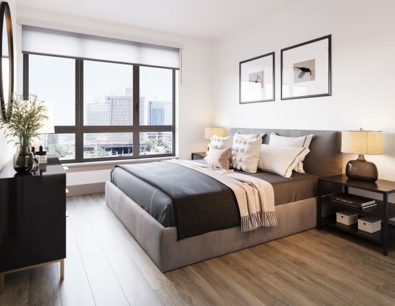 a bedroom with a large window and a bed at Bemiston Place Apartments, Missouri, 63105
