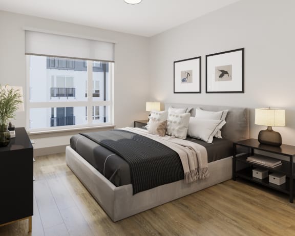 a bedroom with a bed and two windows at Bemiston Place Apartments, Missouri