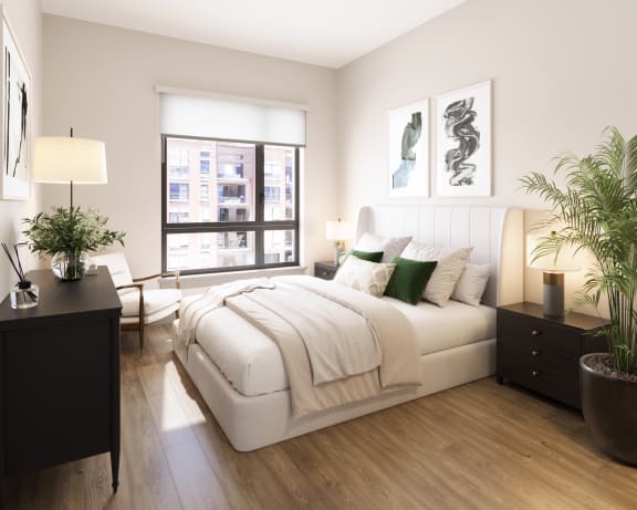 a white bedroom with a large bed and a window at Bemiston Place Apartments, Clayton Missouri