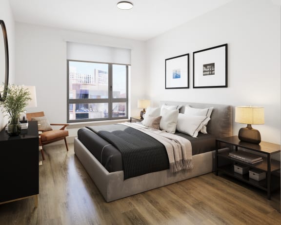 a bedroom with a large bed and a large window at Bemiston Place Apartments, Clayton, MO