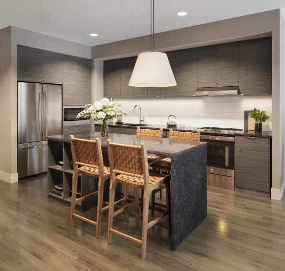 a kitchen with a large island and a table with chairs at Bemiston Place Apartments, Missouri, 63105