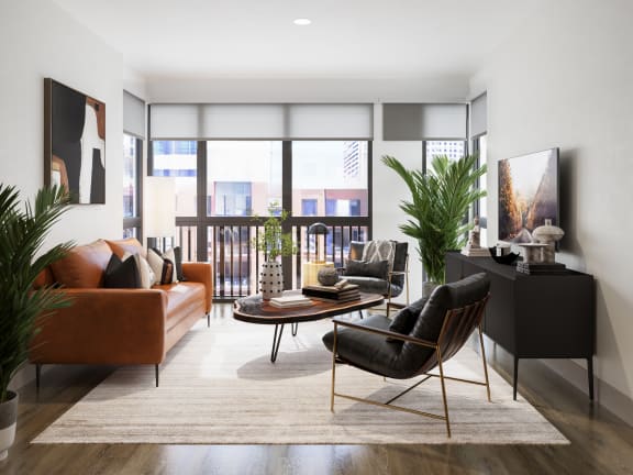 a living room with leather furniture and a balcony at Bemiston Place Apartments, Clayton, MO 63105