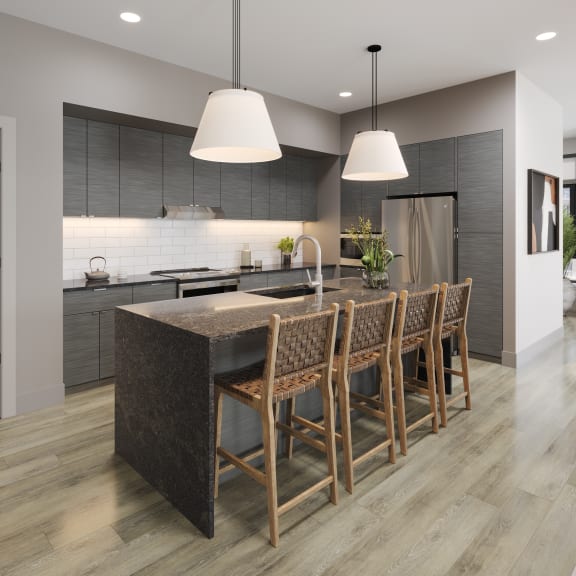 a kitchen with a large island and chairs in a house at Bemiston Place Apartments, Clayton Missouri