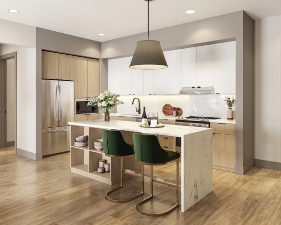 a kitchen with white cabinets and a white island with green chairs at Bemiston Place Apartments, Missouri