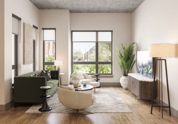 a living room with a large window and a green couch at Bemiston Place Apartments, Clayton, MO