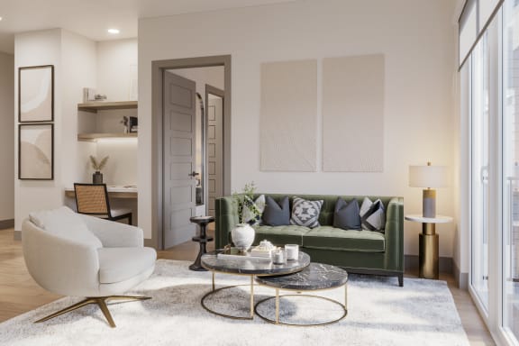 a living room with a green couch and a white rug at Bemiston Place Apartments, Clayton