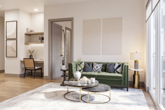 a living room with a green couch and a coffee table at Bemiston Place Apartments, Missouri