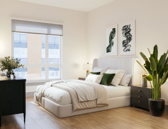 a bedroom with a white bed and a large window at Bemiston Place Apartments, Clayton Missouri