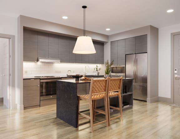 a large kitchen with a black island and wooden chairs at Bemiston Place Apartments, Clayton