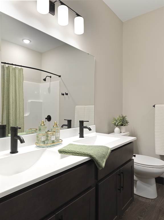 A bathroom with a white sink and a white toilet.