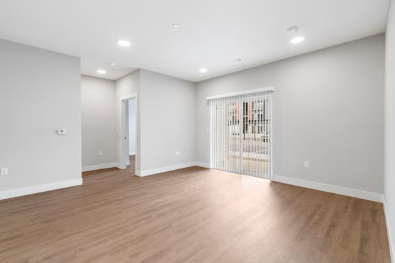 A room with wooden floors and white walls.