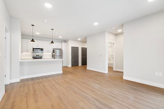 A spacious kitchen with a white cabinet and a white countertop.