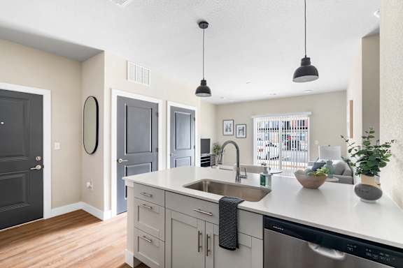 A kitchen with a black oven and a black towel hanging on the cabinet.