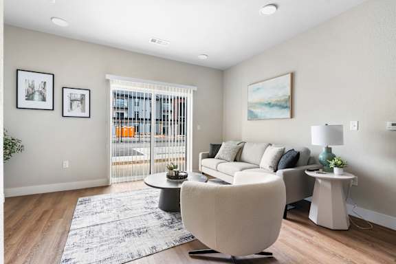 A living room with a white chair and a grey sofa.