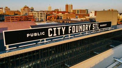 a public city foundry sign on the top of a building at One Foundry Way Apartments, St Louis, 63110