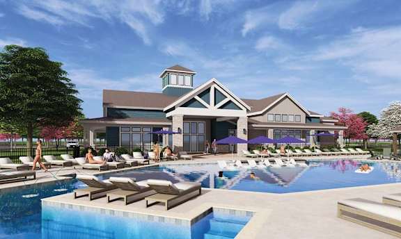 A pool area with people sunbathing and a building in the background at Montage at Hawk Ridge Apartments, Missouri