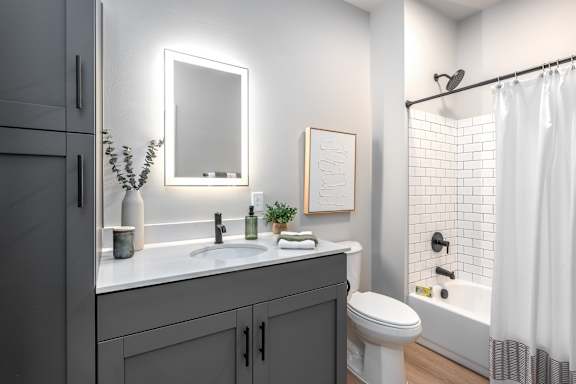 Bathroom with white subway tile and gray vanity at Mila Apartments, Ellisville, MO 63011