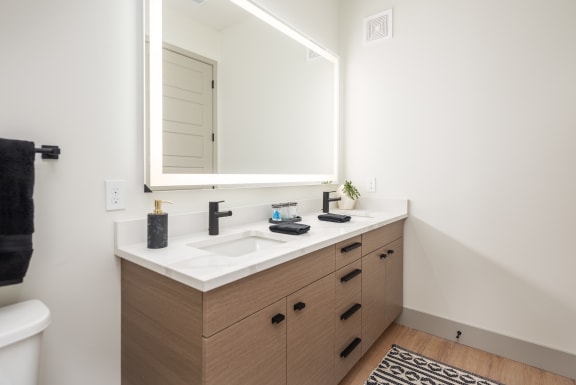a bathroom with a sink and a mirror at Bemiston Place Apartments, Clayton, MO