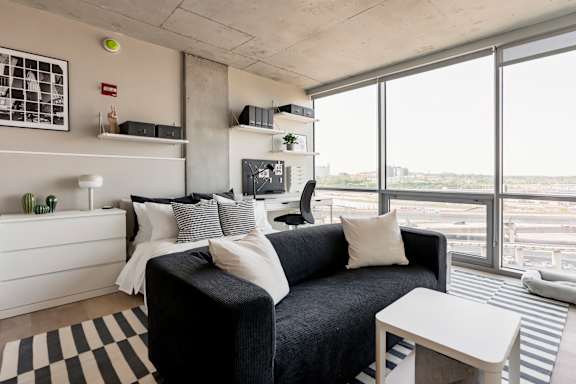 A black and white checkered rug is on the floor. at One Foundry Way Apartments, St Louis, MO, 63110