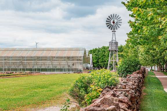 A windmill stands next to a green field at French District Villas Apartments, St. Charles, MO 63301