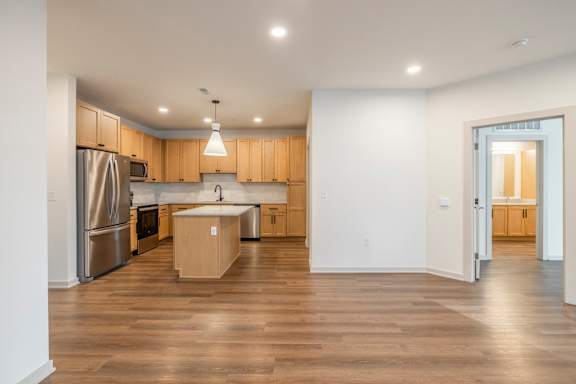 A kitchen with wooden cabinets and a refrigerator.