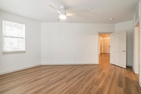 A room with wooden floors and white walls.