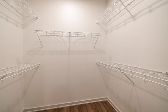 Empty white shelves in a room.