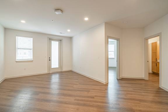 A room with wooden floors and white walls.