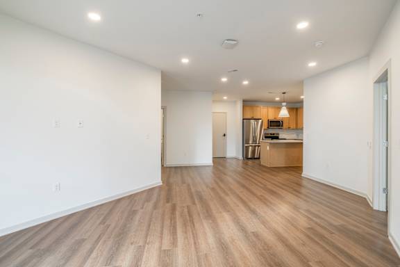A room with wooden flooring and white walls.