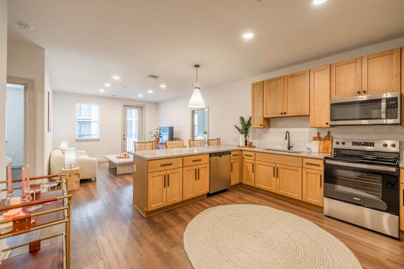 A modern kitchen with wooden cabinets and stainless steel appliances.