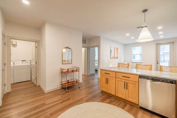 A kitchen with wooden floors and white walls.