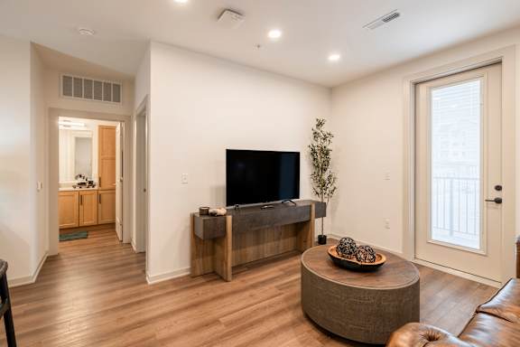 A living room with a flat screen TV and a wooden cabinet.
