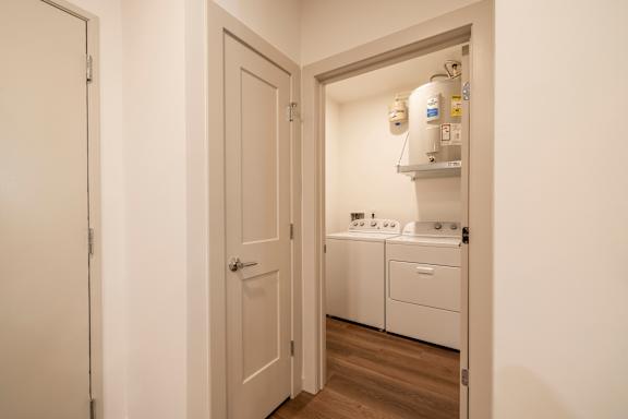 A small laundry room with a washer and dryer.