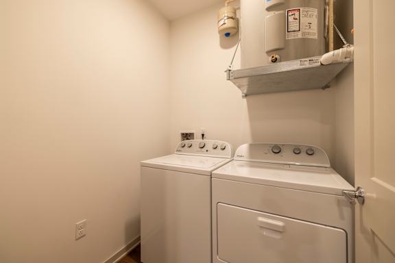 A small laundry room with a washer and dryer.