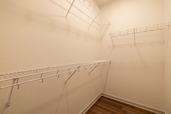 A white wall with a metal rack on it.