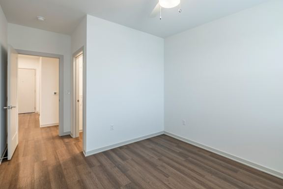 A room with white walls and wood flooring.