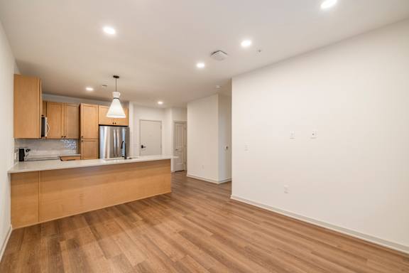 A kitchen with wooden floors and white walls.