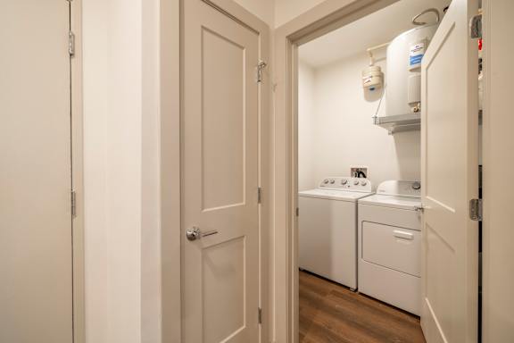 A small laundry room with a washer and dryer.