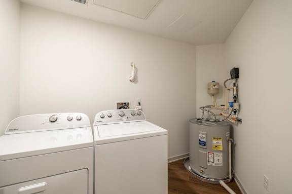 A small laundry room with a washer and dryer.