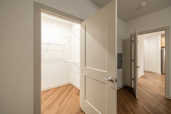 A white door is open to a hallway.