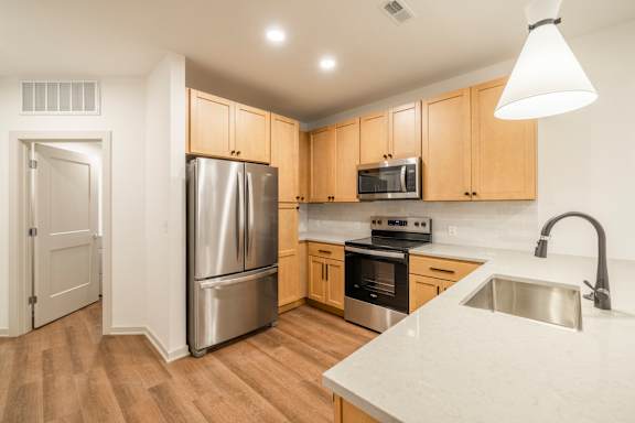 A kitchen with wooden cabinets and stainless steel appliances.