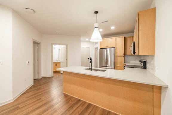 A kitchen with wooden cabinets and a white countertop.