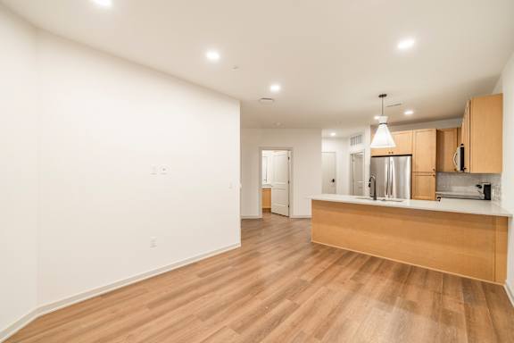 A kitchen with a wooden counter and white walls.