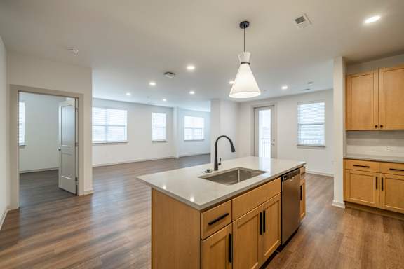 A kitchen with wooden cabinets and a white countertop.