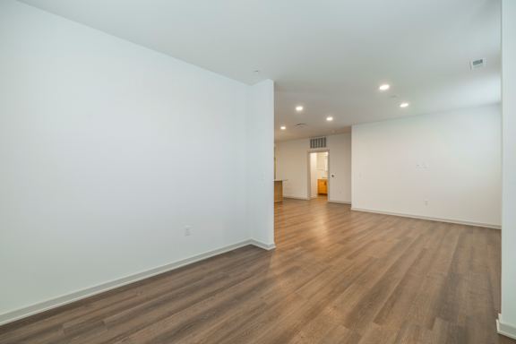 A room with wooden floors and white walls.
