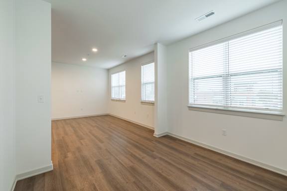 A room with wooden floors and white walls.