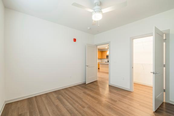 A room with a white wall and a wooden floor.