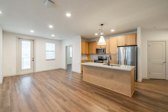 A kitchen with wooden cabinets and a white countertop.